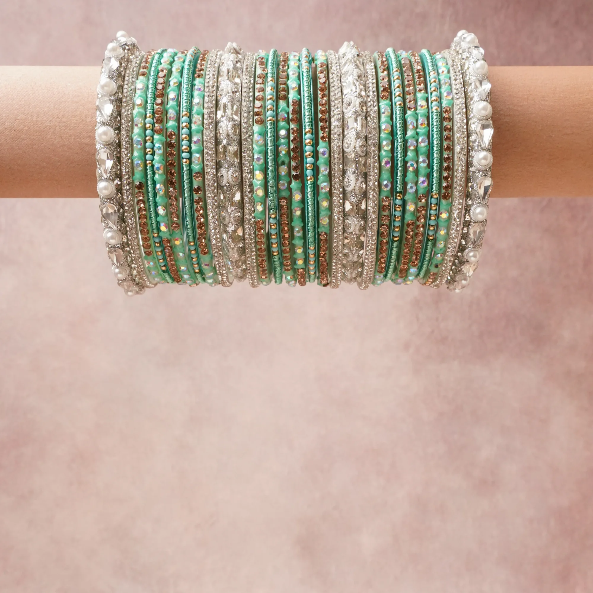 A grounding Aqua Green forms the heart of the set, while touches of Crystal White, Rose Gold, Iridescent, Pearl White add charm.

A thoughtful composition of Silver-Tone Alloy, Crystal Rhinestones, Faux Pearls, Enamel, Glass Beads, designed to feel complete without being heavy.
Each element layers seamlessly, creating a look that is refined, wearable and quietly striking.